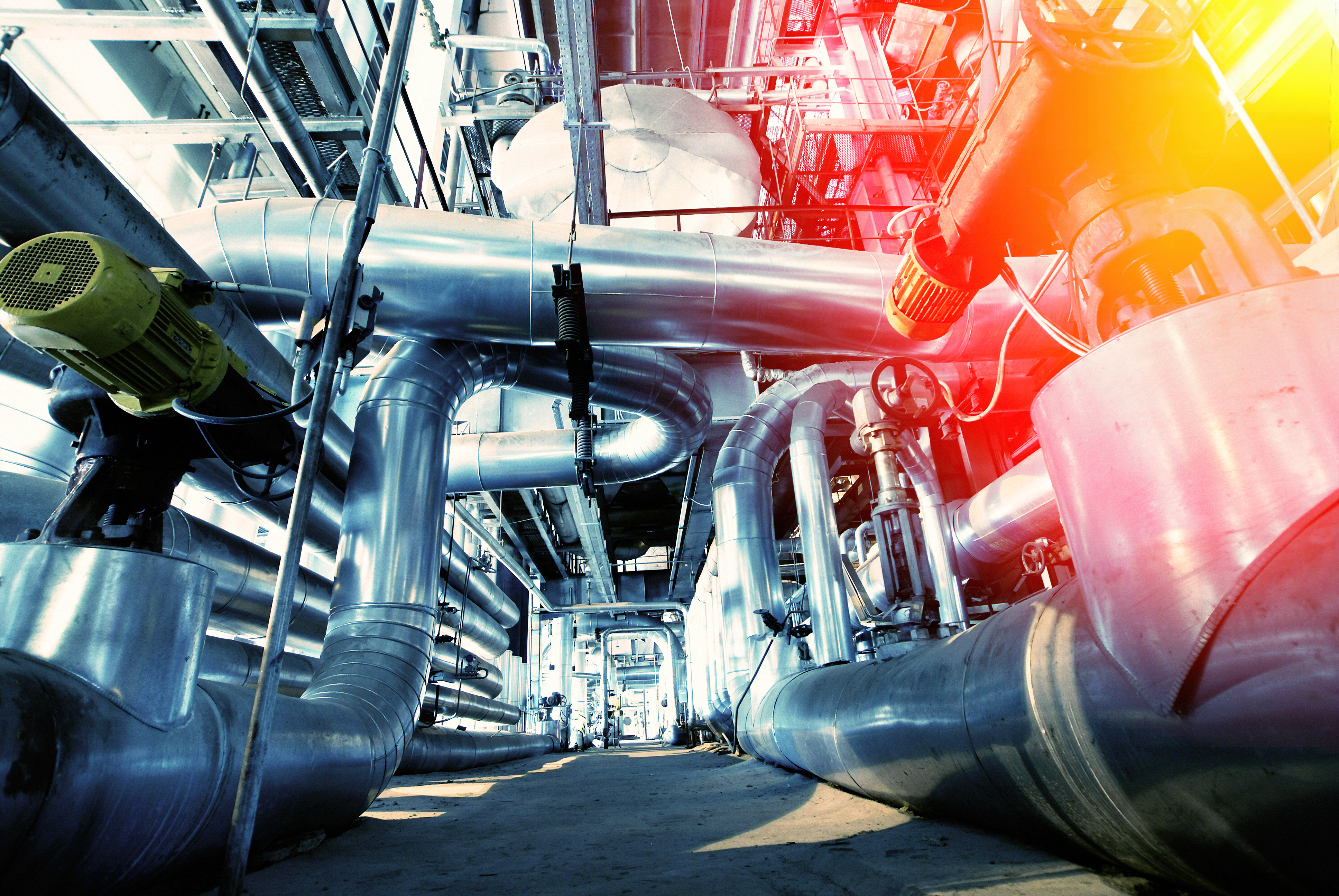 Equipment, cables and piping as found inside of a modern industrial power plant