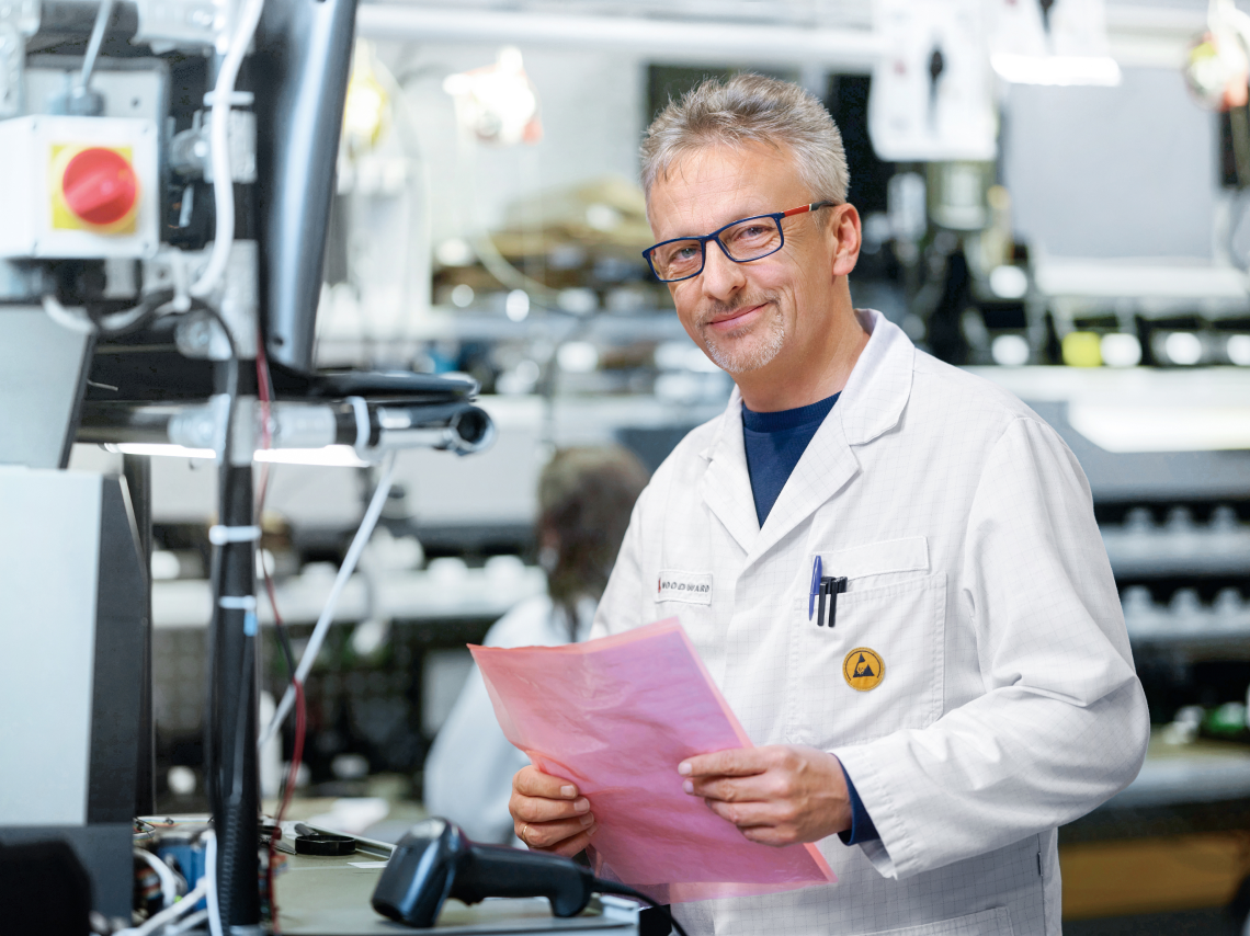 male in white lab coat in a technical environment